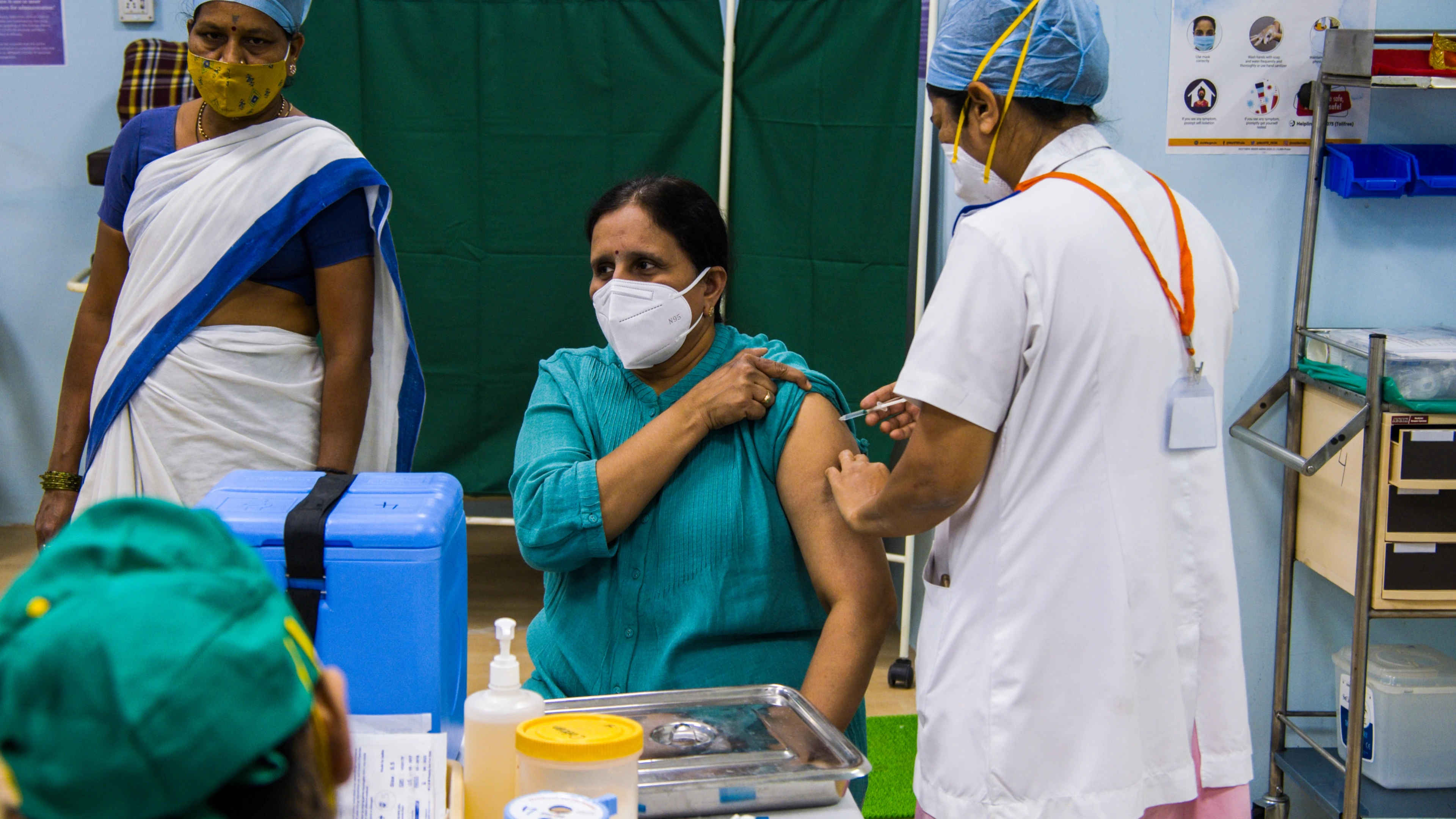 Nurses vaccinate a patient